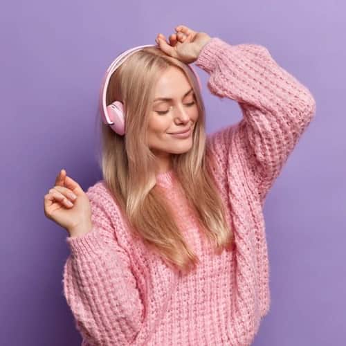 Woman dancing to brand fit music