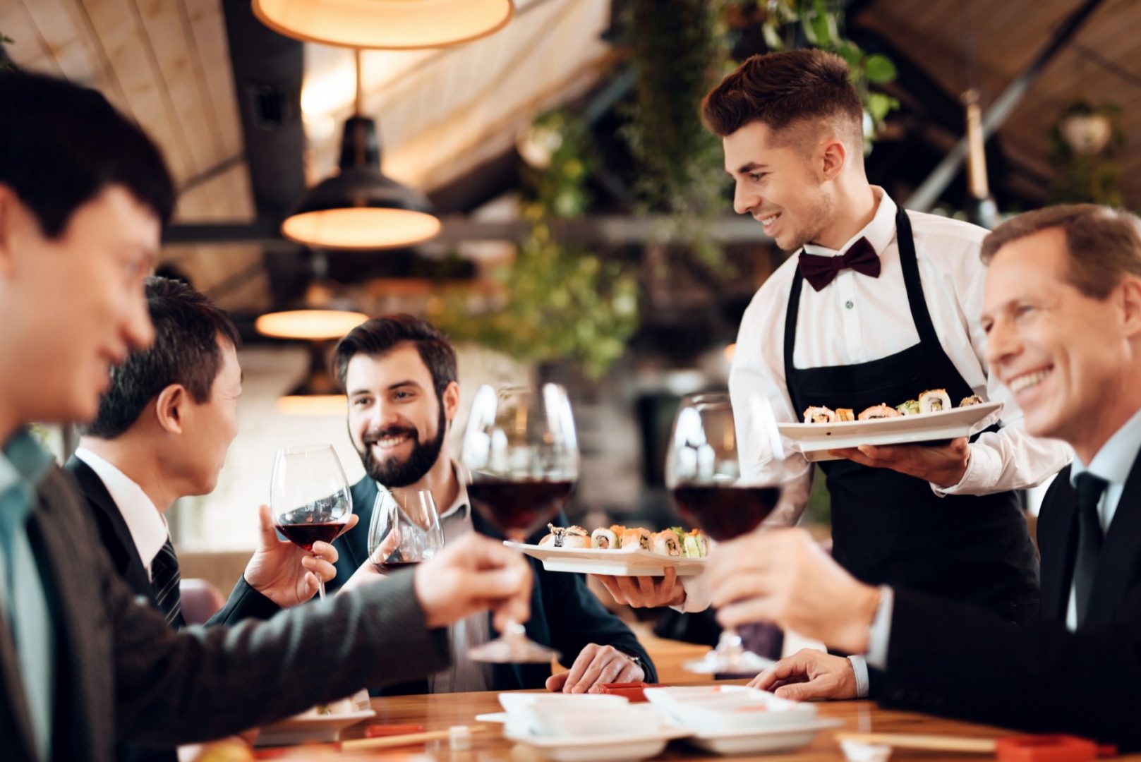 Waiter serving drinks in a cafe restaurant